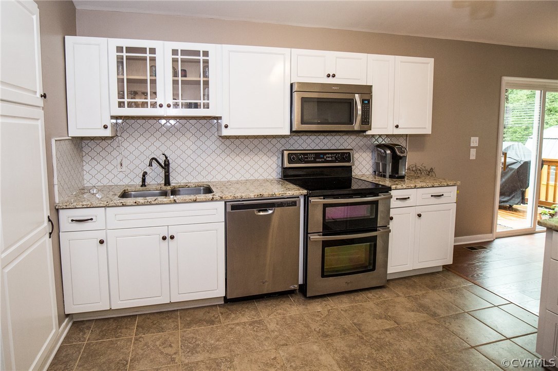 18196 Old Ridge Road Montpelier, VA 23192 - Photo 5 of 40 a kitchen with stainless steel appliances a stove microwave and cabinets