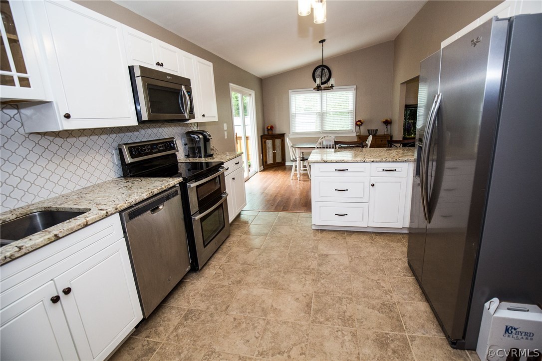 18196 Old Ridge Road Montpelier, VA 23192 - Photo 6 of 40 a kitchen with white cabinets and stainless steel appliances