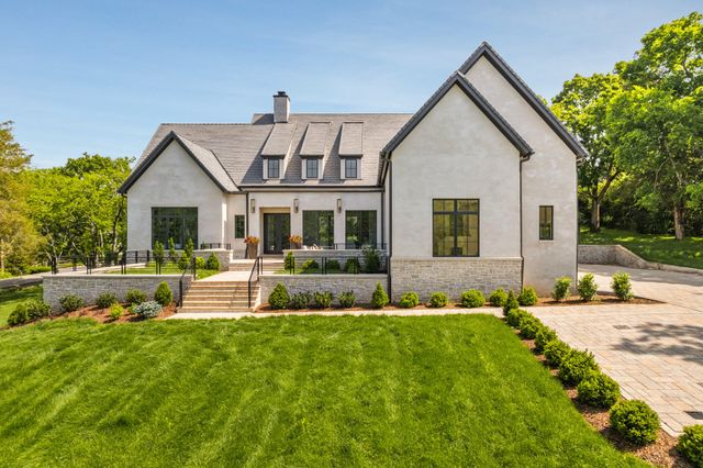 a front view of house with yard and green space