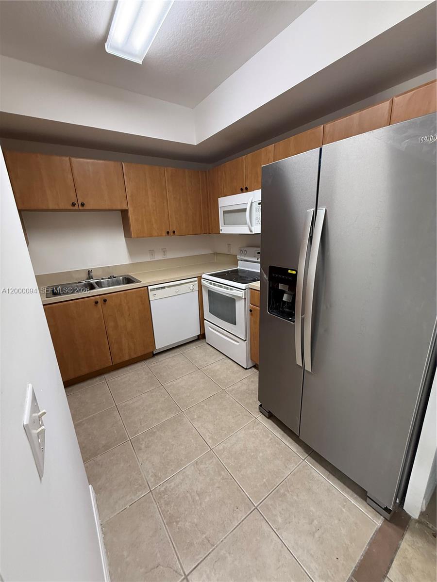 119 Southwest 6th Avenue, Unit 709 Miami, FL 33130 - Photo 2 of 18 a kitchen with stainless steel appliances granite countertop a refrigerator and a stove top oven