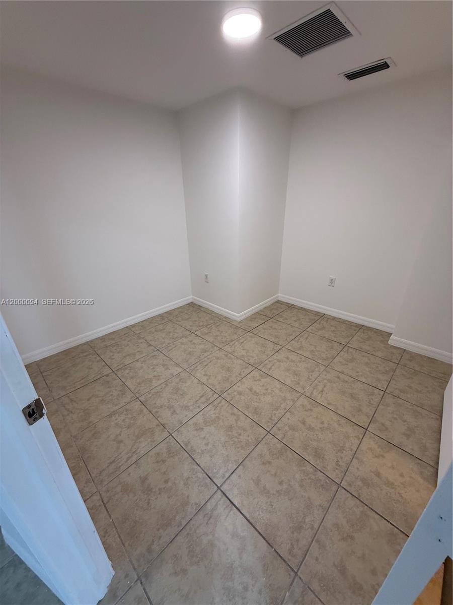 119 Southwest 6th Avenue, Unit 709 Miami, FL 33130 - Photo 6 of 18 an empty room with windows