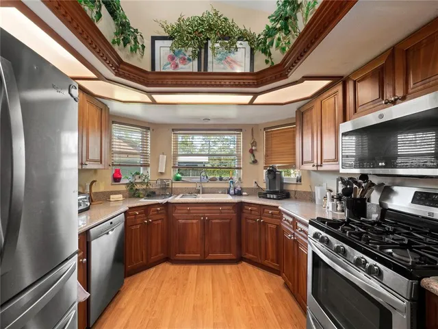 a kitchen with stainless steel appliances sink stove and cabinets