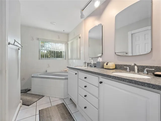 a bathroom with a granite countertop sink mirror and double