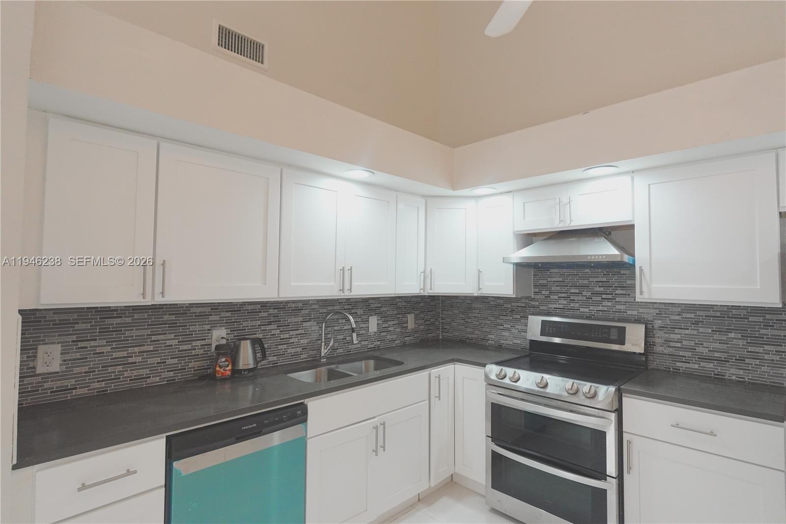 518 Northeast 48th Street, Unit 518 Boca Raton, FL 33431 - Photo 15 of 32 a kitchen with stainless steel appliances granite countertop a sink and cabinets