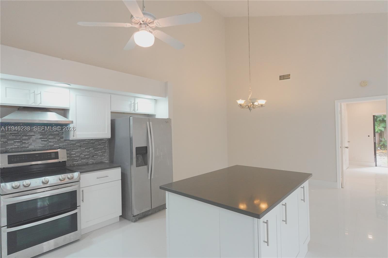 518 Northeast 48th Street, Unit 518 Boca Raton, FL 33431 - Photo 2 of 32 a kitchen with granite countertop a stove oven and refrigerator