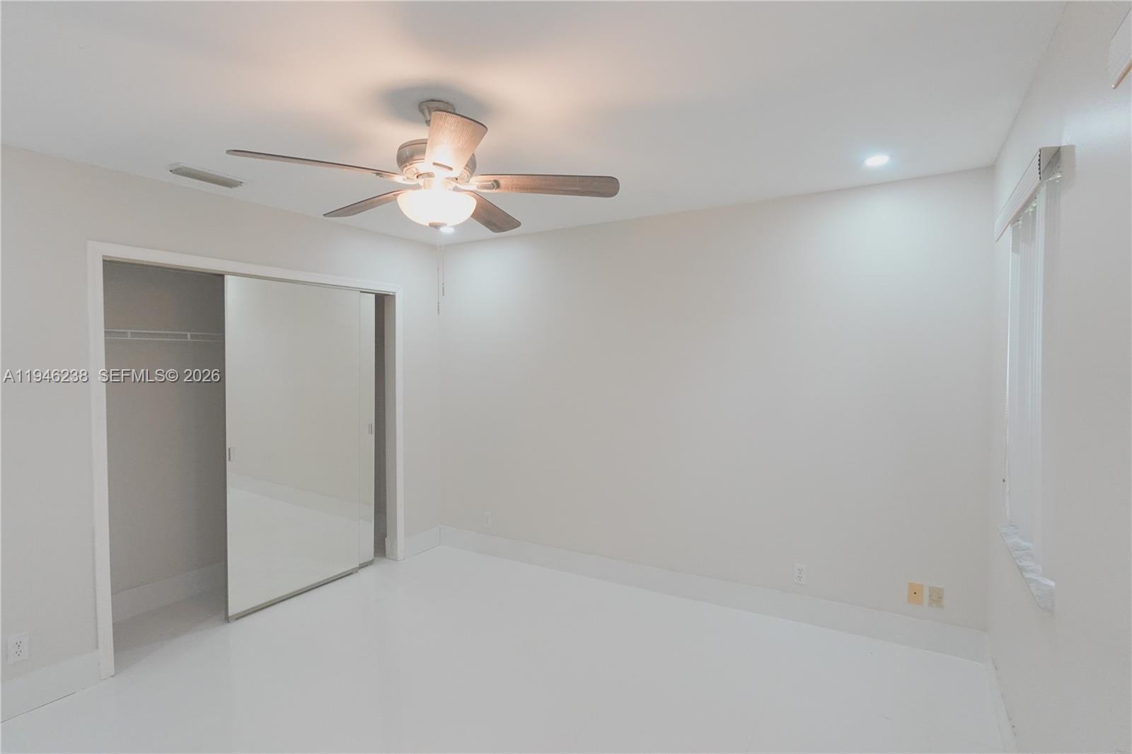 518 Northeast 48th Street, Unit 518 Boca Raton, FL 33431 - Photo 21 of 32 an empty room with a fan & a ceiling fan