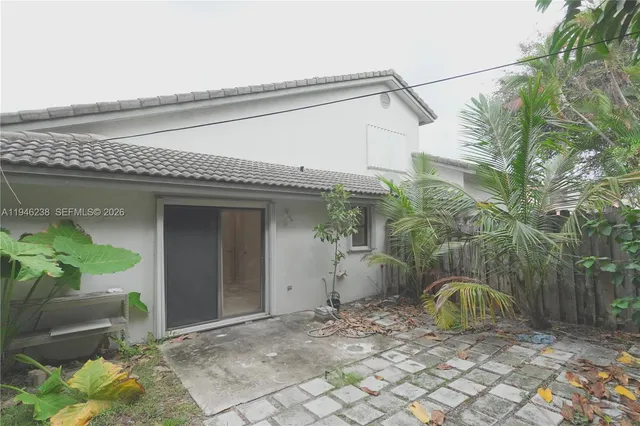 a car parked in front of white house