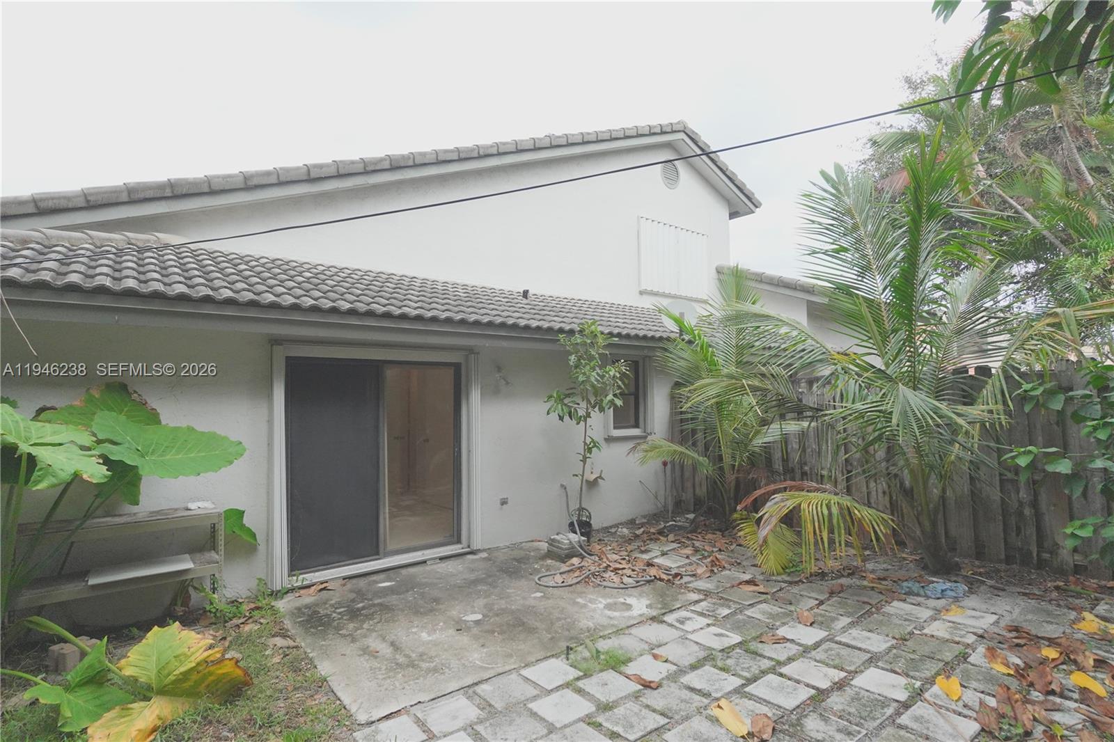 518 Northeast 48th Street, Unit 518 Boca Raton, FL 33431 - Photo 30 of 32 a view of a house with a chair and potted plants