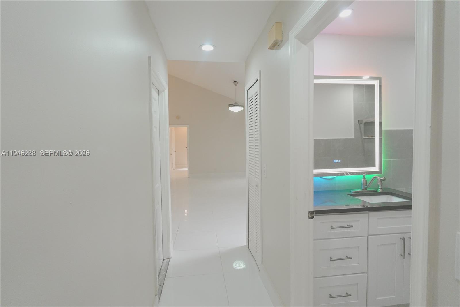 518 Northeast 48th Street, Unit 518 Boca Raton, FL 33431 - Photo 3 of 32 a bathroom with a granite countertop sink and mirror