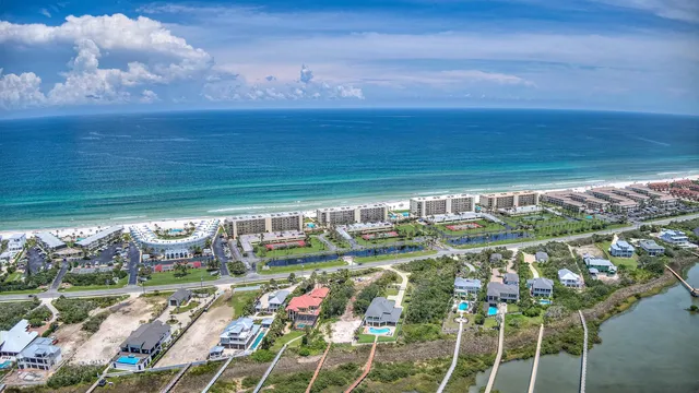 a view of swimming pool with a yard and potted plants