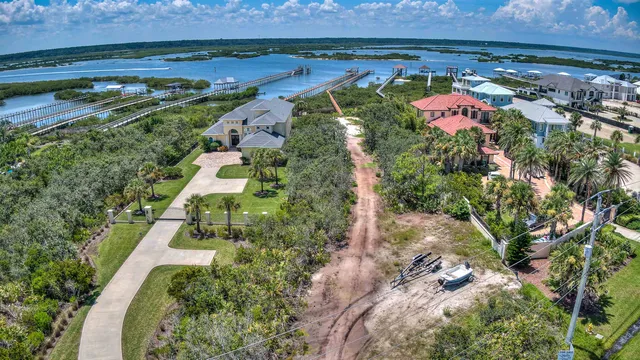 an aerial view of a houses with a yard