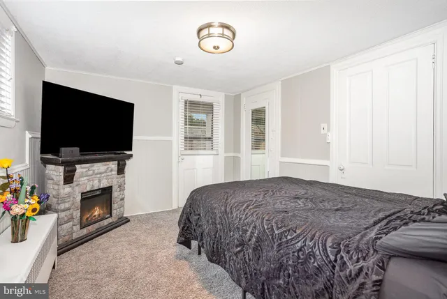 a bedroom with a flat screen tv and a fireplace