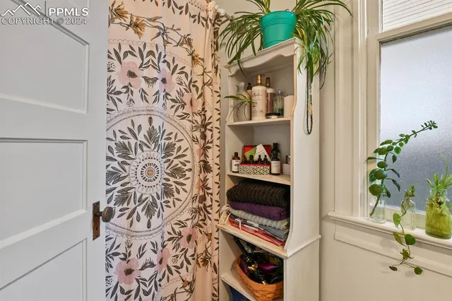 a view of a entryway with paintings on the wall