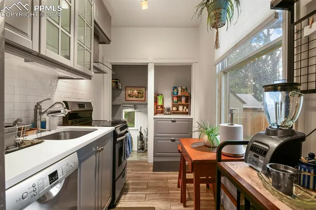 a kitchen with stainless steel appliances granite countertop a stove a sink dishwasher and cabinets