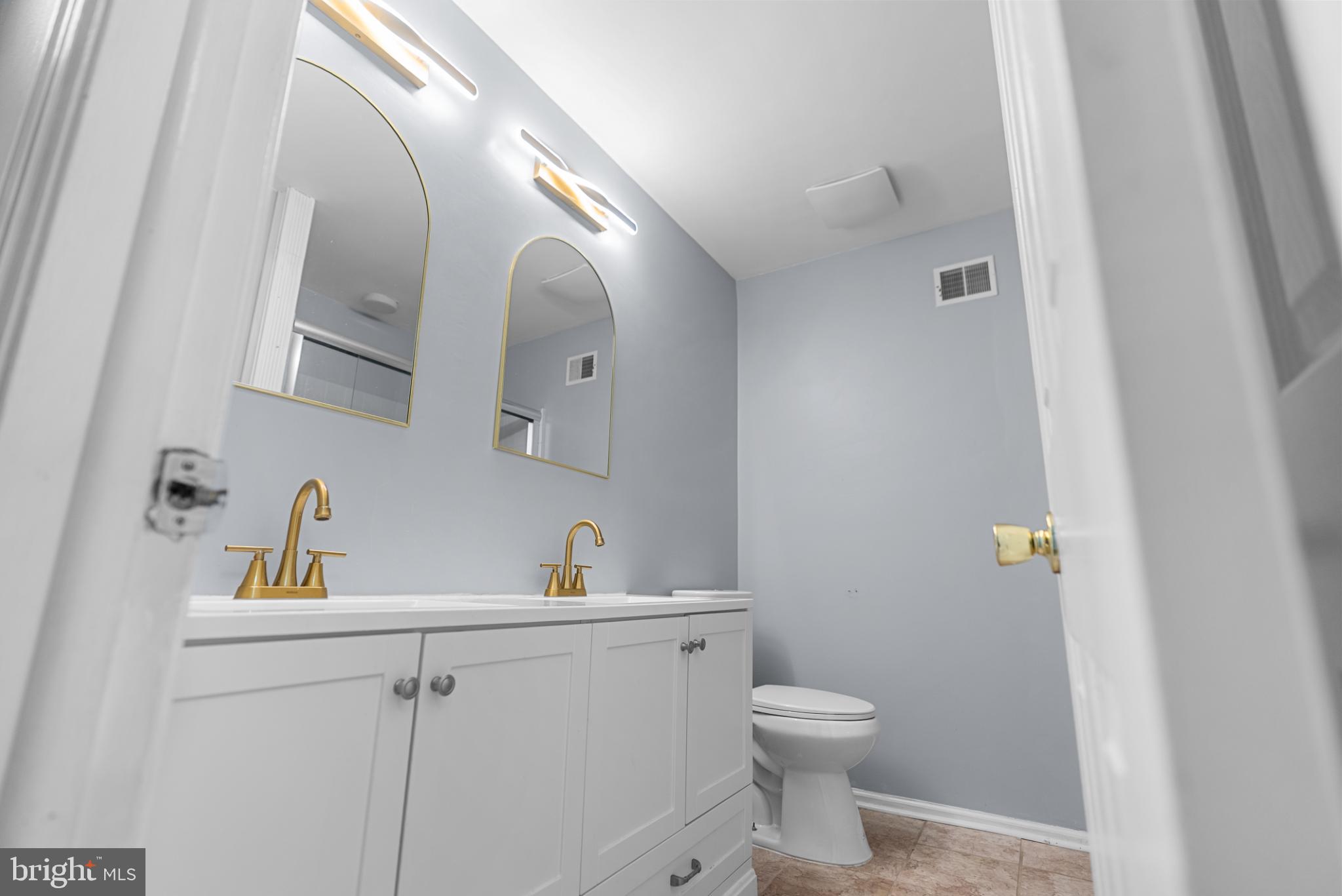 1137 Kingsbury Road Owings Mills, MD 21117 - Photo 21 of 24 a bathroom with a toilet a sink and mirror
