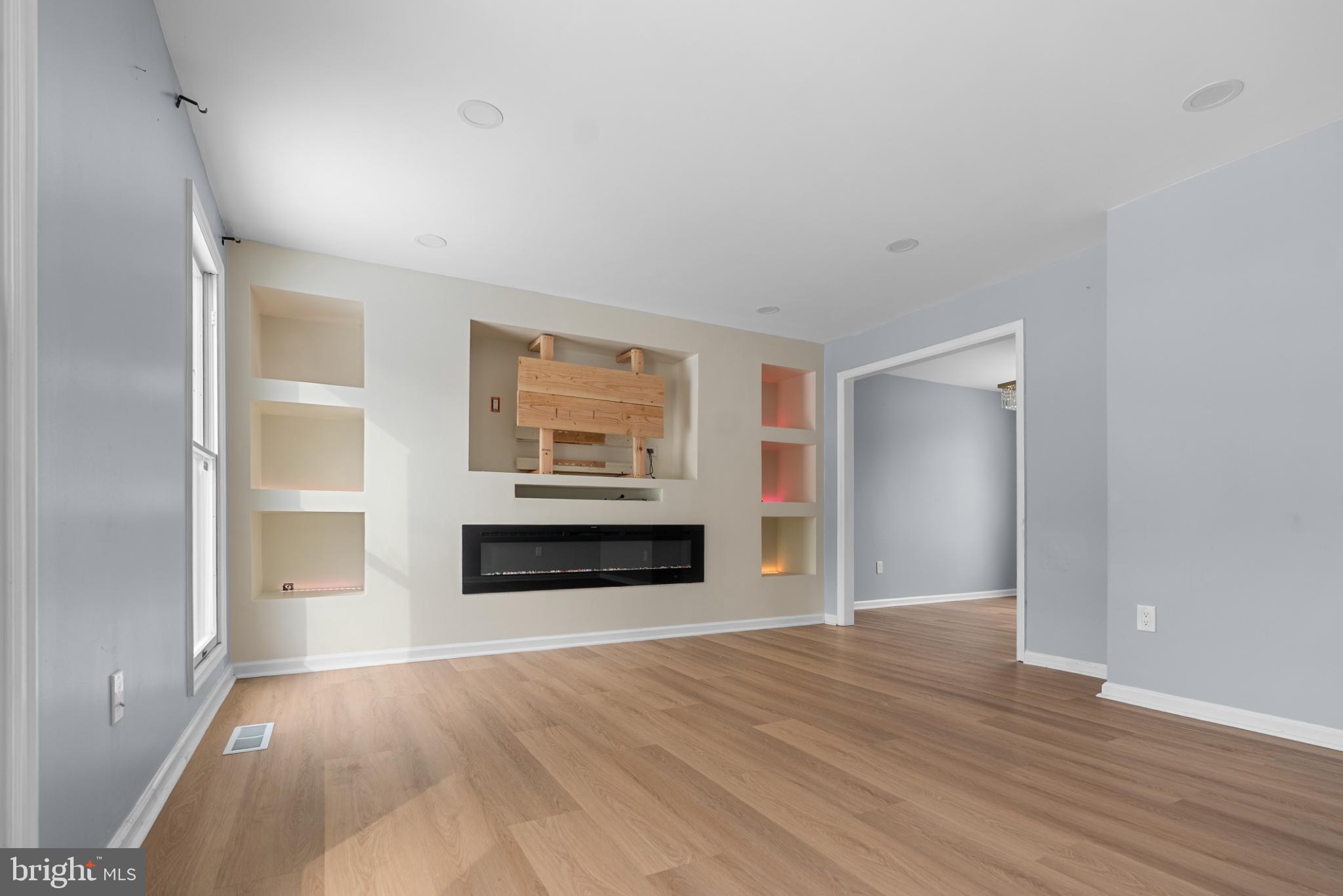 1137 Kingsbury Road Owings Mills, MD 21117 - Photo 3 of 24 wooden floor fireplace and windows in an empty room