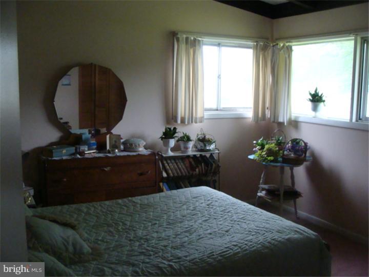 104 Valley Green Drive Aston, PA 19014 - Photo 11 of 20 a bedroom with a bed dresser and a window