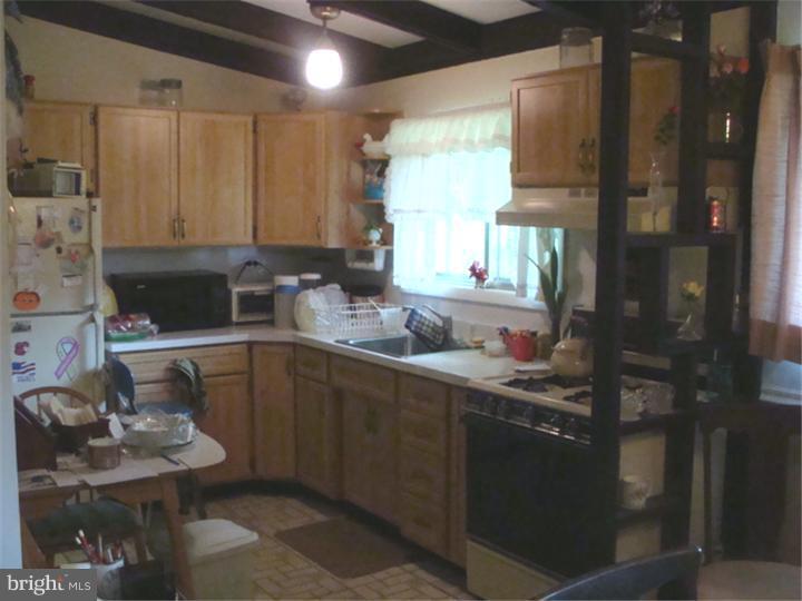 104 Valley Green Drive Aston, PA 19014 - Photo 8 of 20 a kitchen with a sink and a stove top oven