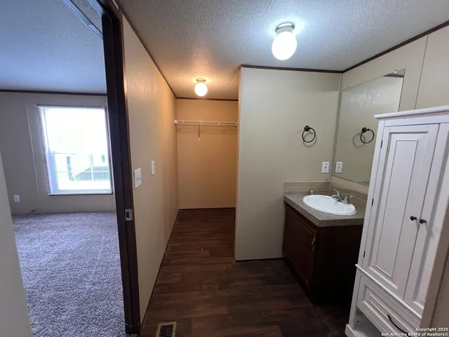 a bathroom with a sink a toilet a mirror and vanity