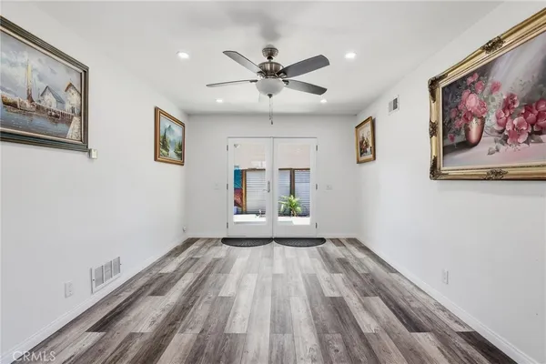 a view of empty room with wooden floor