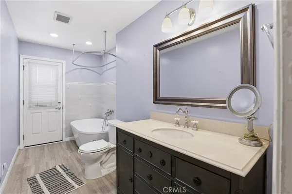 a bathroom with a sink a toilet and a mirror