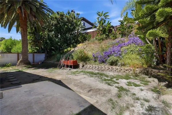 a backyard of a house with flower plants