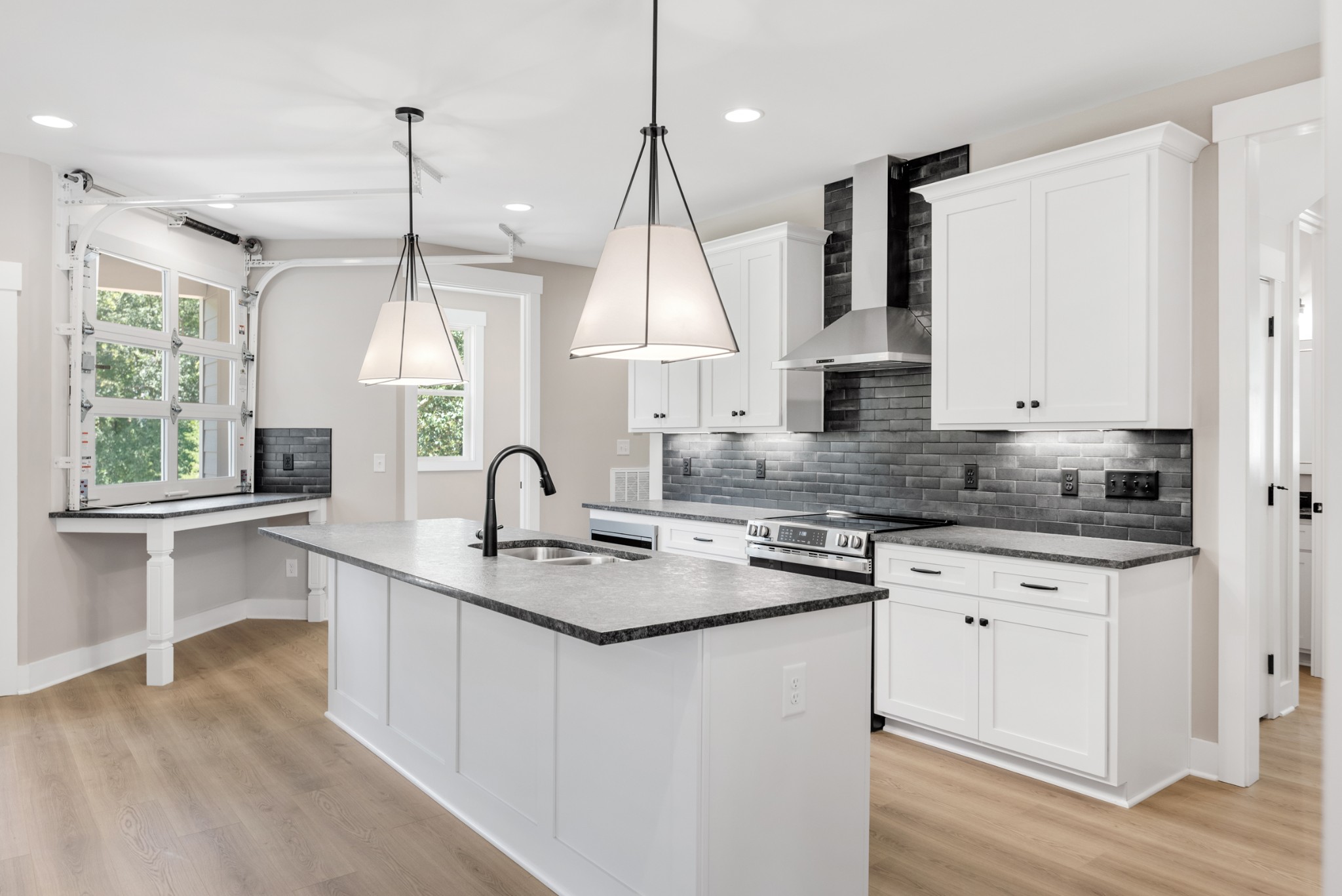 2033 Graceland Drive Goodlettsville, TN 37072 - Photo 11 of 40 a kitchen with kitchen island granite countertop a sink a counter space appliances and a window