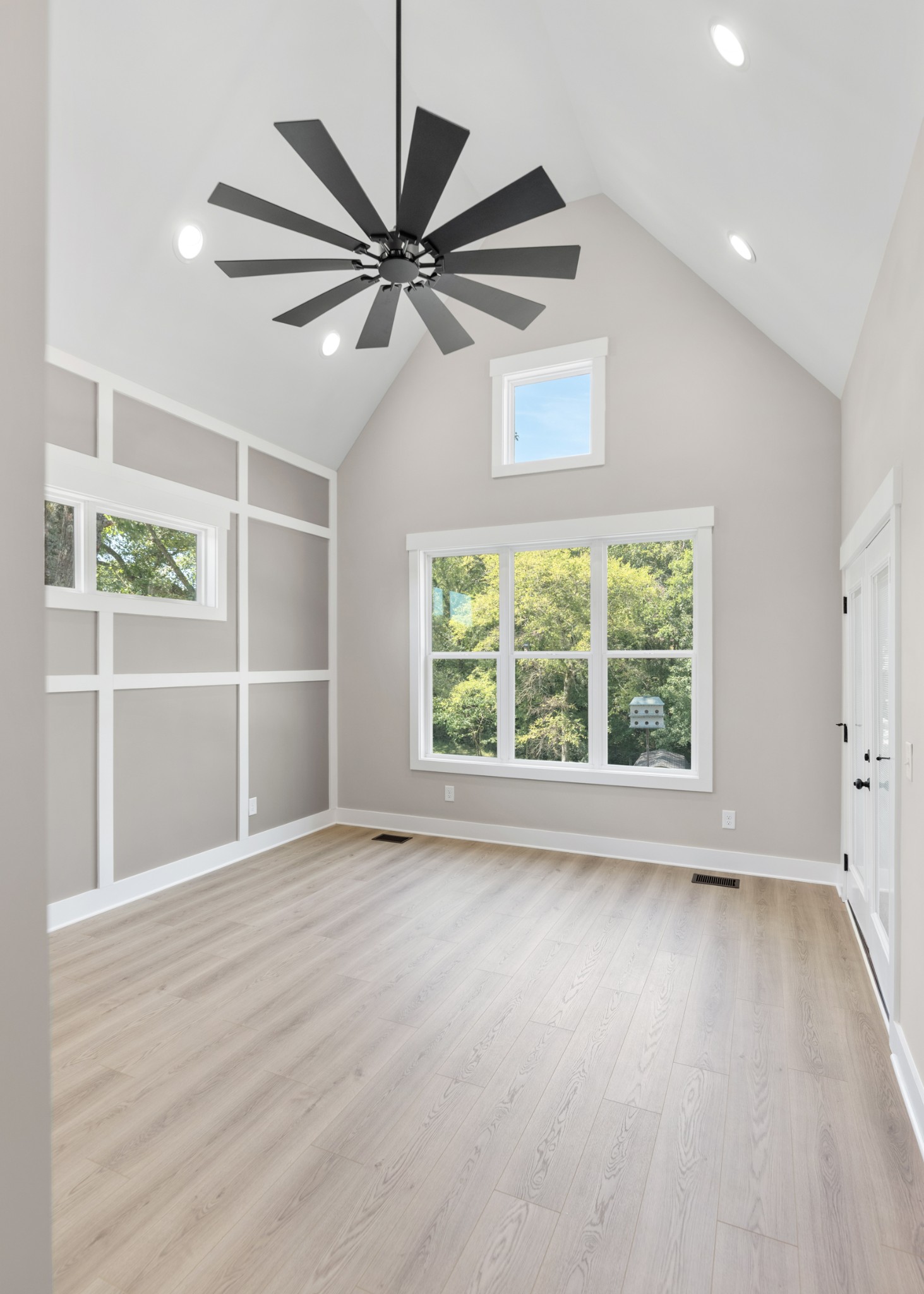 2033 Graceland Drive Goodlettsville, TN 37072 - Photo 17 of 40 an empty room with wooden floor fan and windows