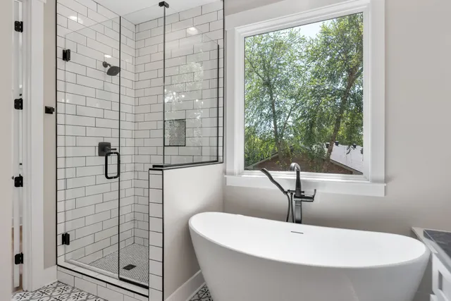 a bathroom with a bathtub and shower
