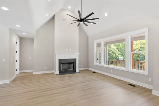 a view of livingroom window fireplace and wooden floor