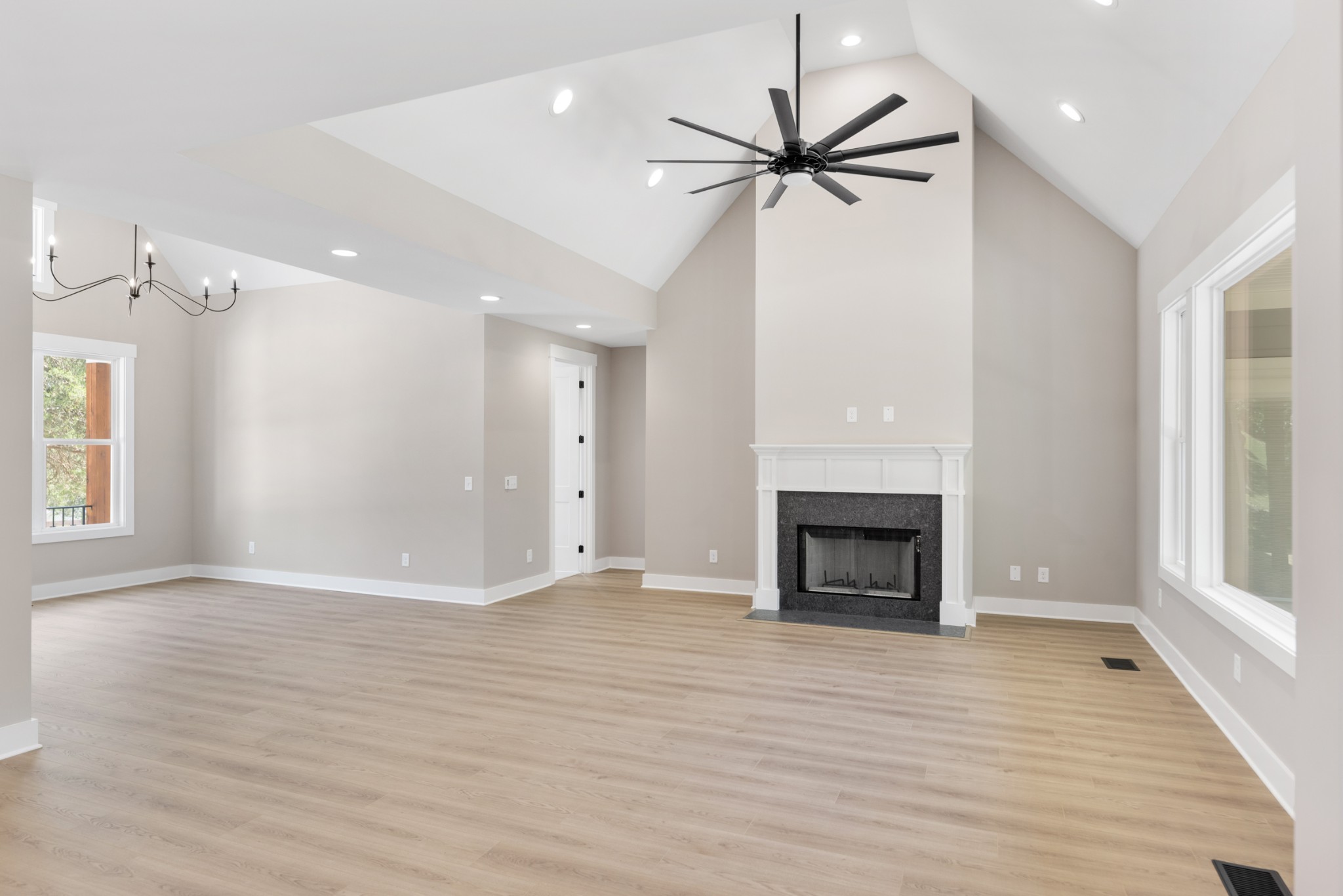 2033 Graceland Drive Goodlettsville, TN 37072 - Photo 5 of 40 an empty room with wooden floor fireplace and windows