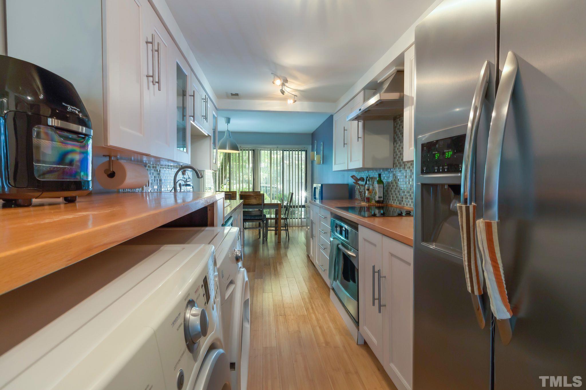 1770 Quail Ridge Road Raleigh, NC 27609 - Photo 11 of 26 a kitchen with stainless steel appliances granite countertop a refrigerator a stove and a sink