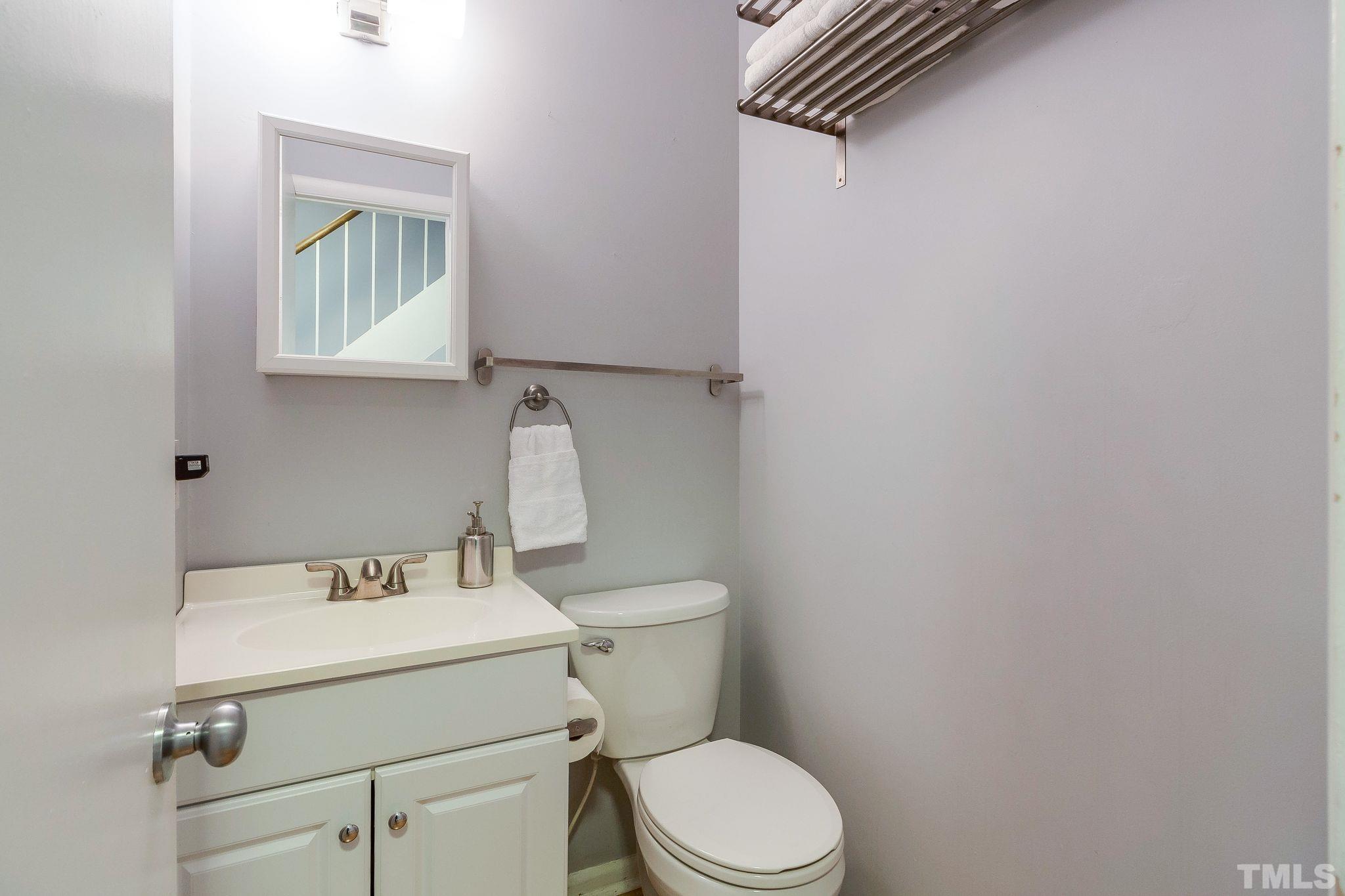 1770 Quail Ridge Road Raleigh, NC 27609 - Photo 13 of 26 a bathroom with a toilet sink and mirror