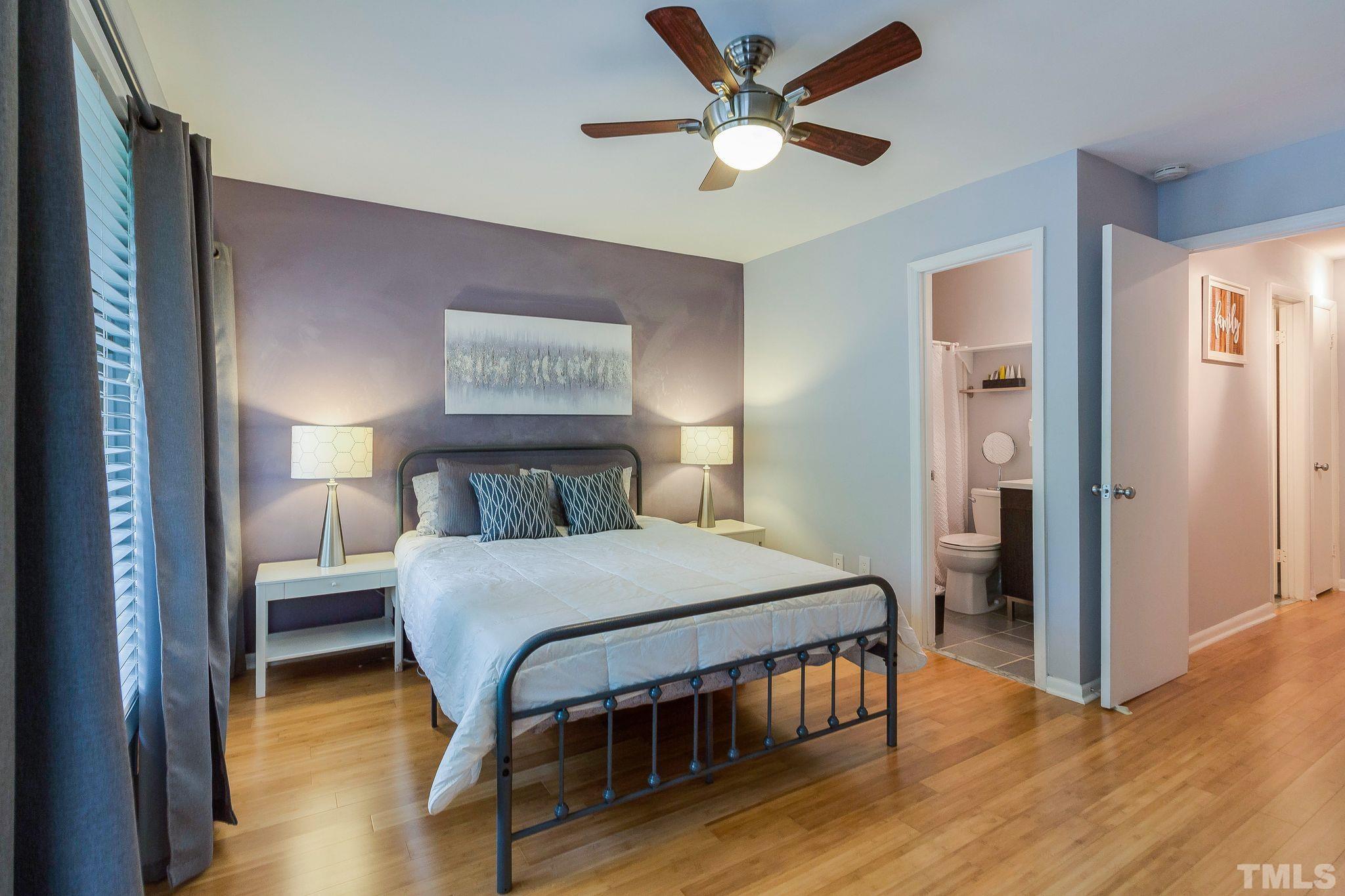 1770 Quail Ridge Road Raleigh, NC 27609 - Photo 20 of 26 a bedroom with a bed and a table