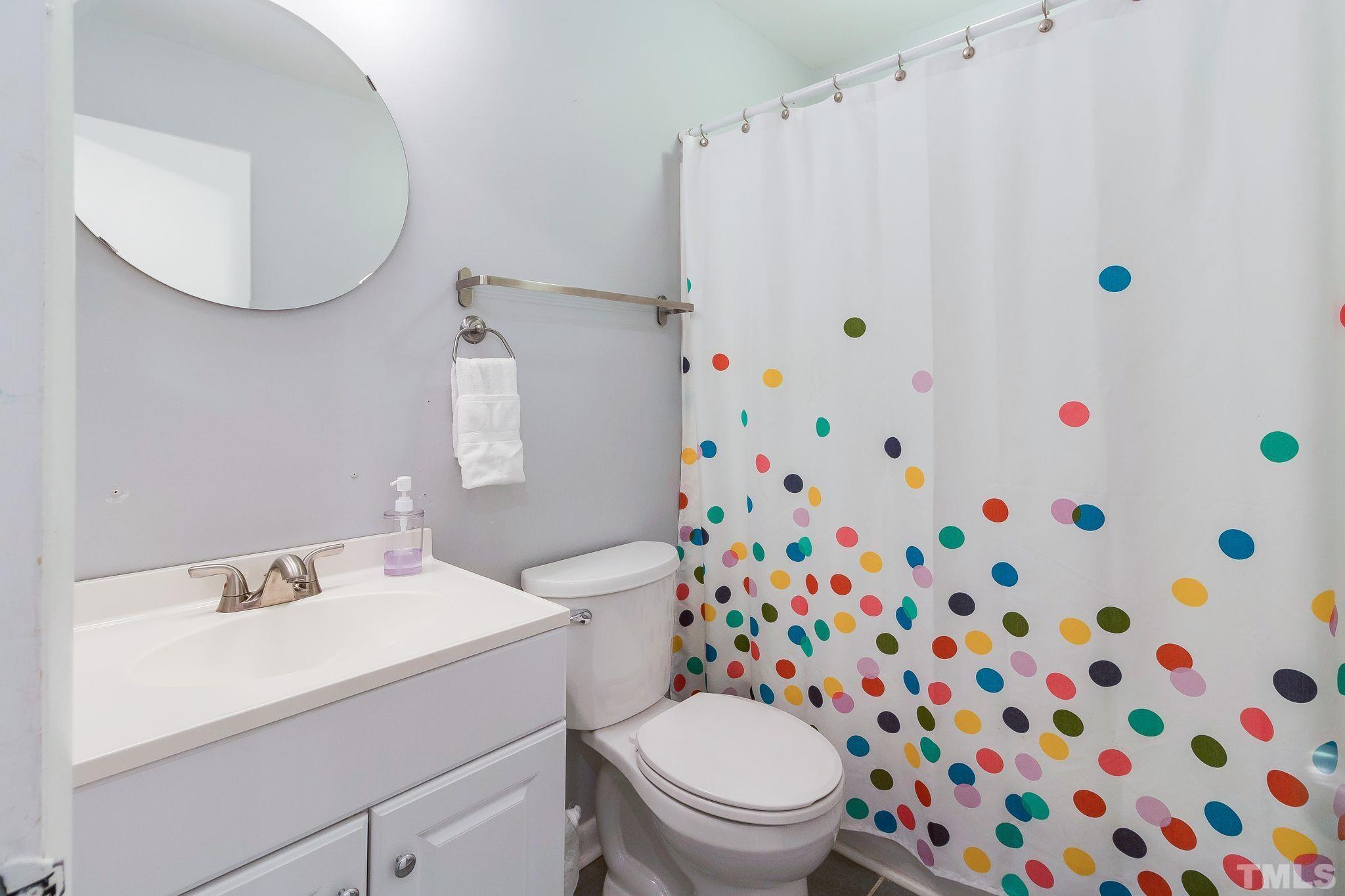 1770 Quail Ridge Road Raleigh, NC 27609 - Photo 23 of 26 a white toilet sitting next to a sink curtain and a sink