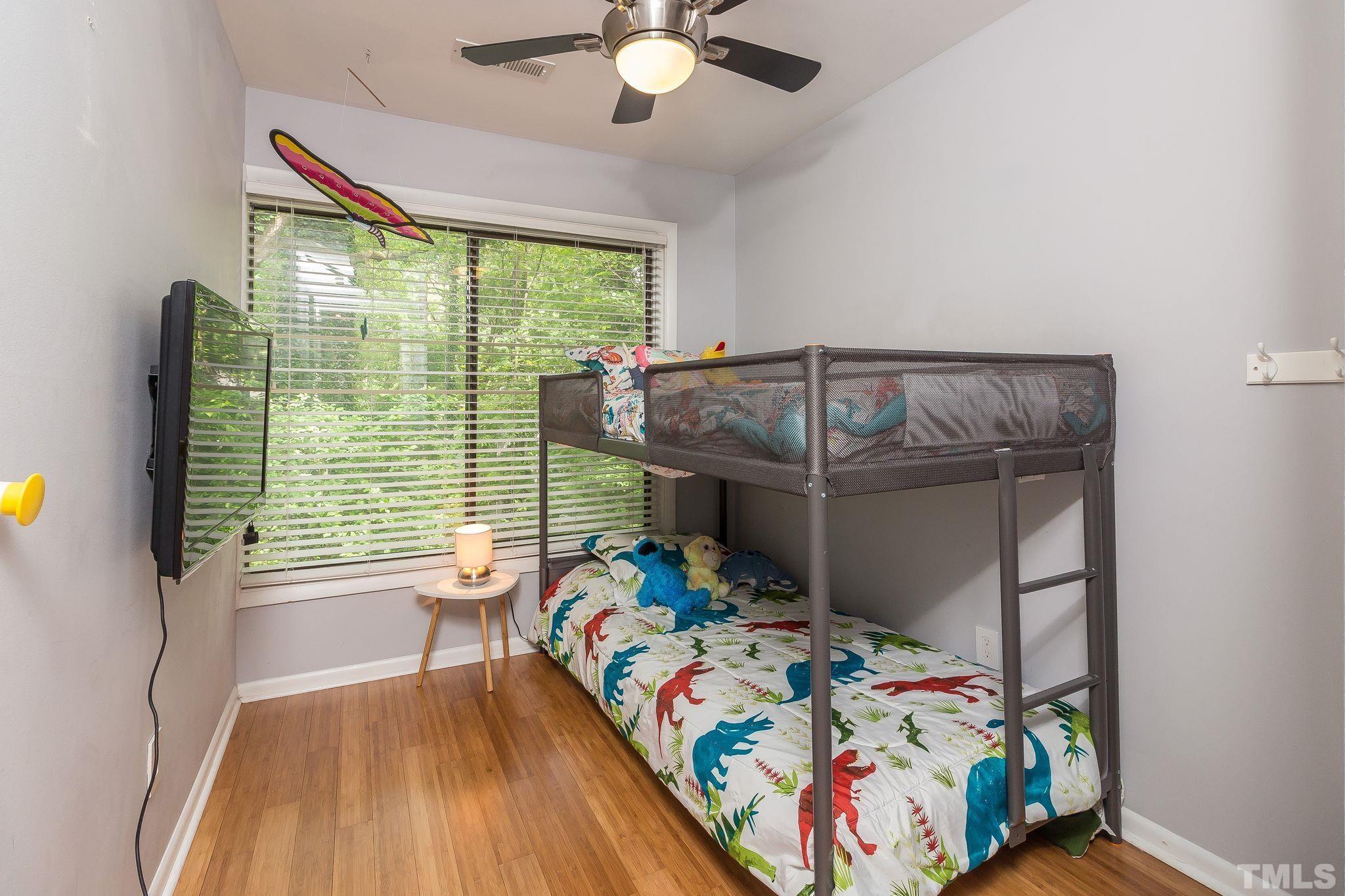 1770 Quail Ridge Road Raleigh, NC 27609 - Photo 24 of 26 a bedroom with a bed and a chandelier