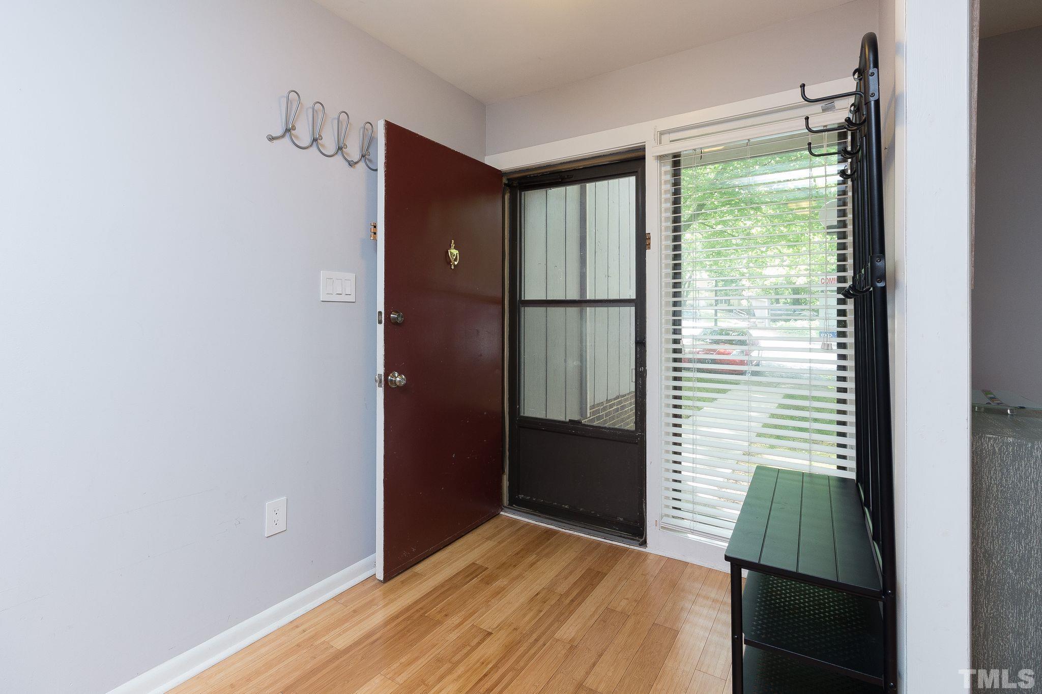 1770 Quail Ridge Road Raleigh, NC 27609 - Photo 5 of 26 a view of hallway with wooden floor and cabinet