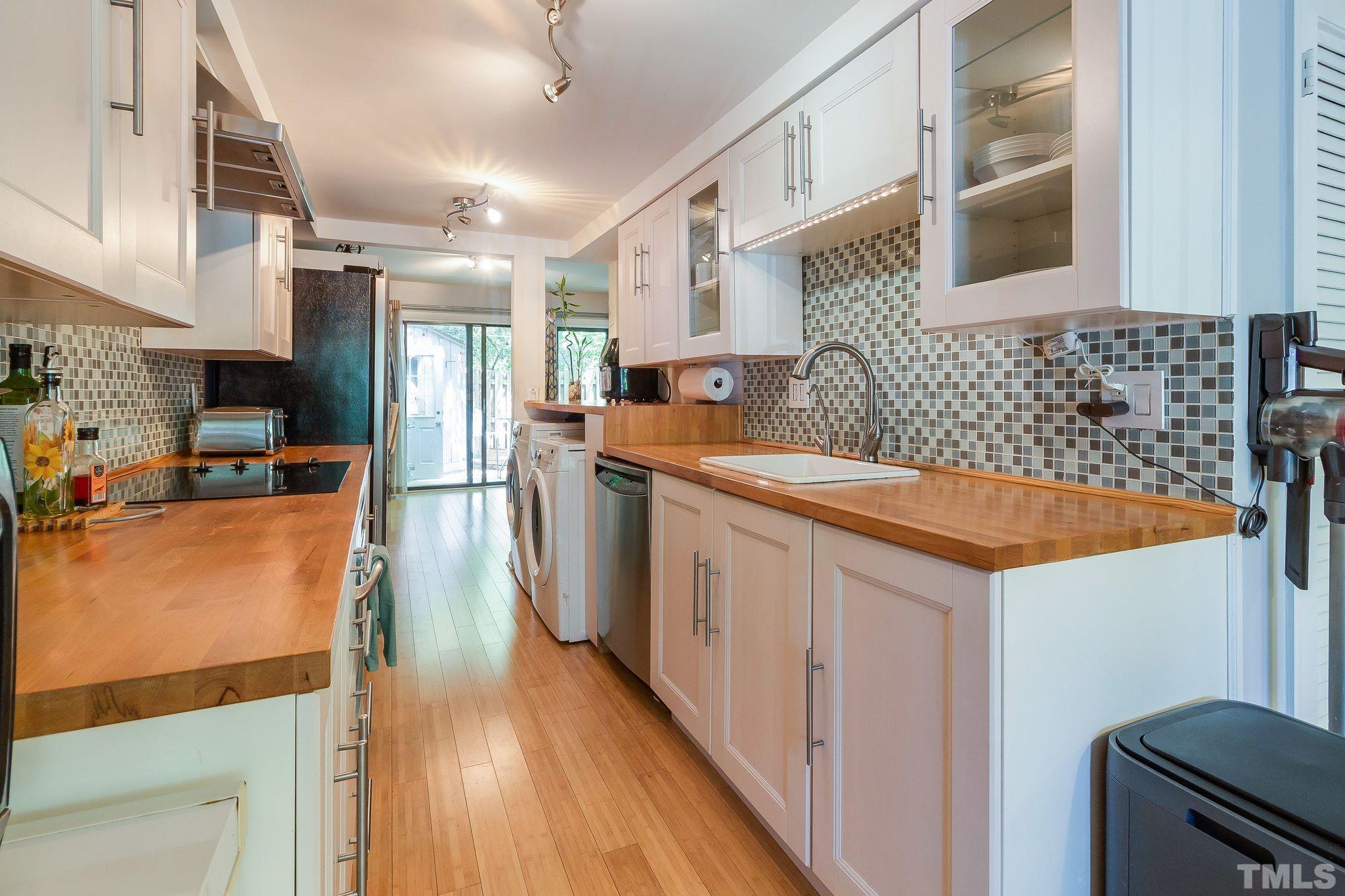 1770 Quail Ridge Road Raleigh, NC 27609 - Photo 10 of 26 a kitchen with stainless steel appliances granite countertop a sink stove and refrigerator