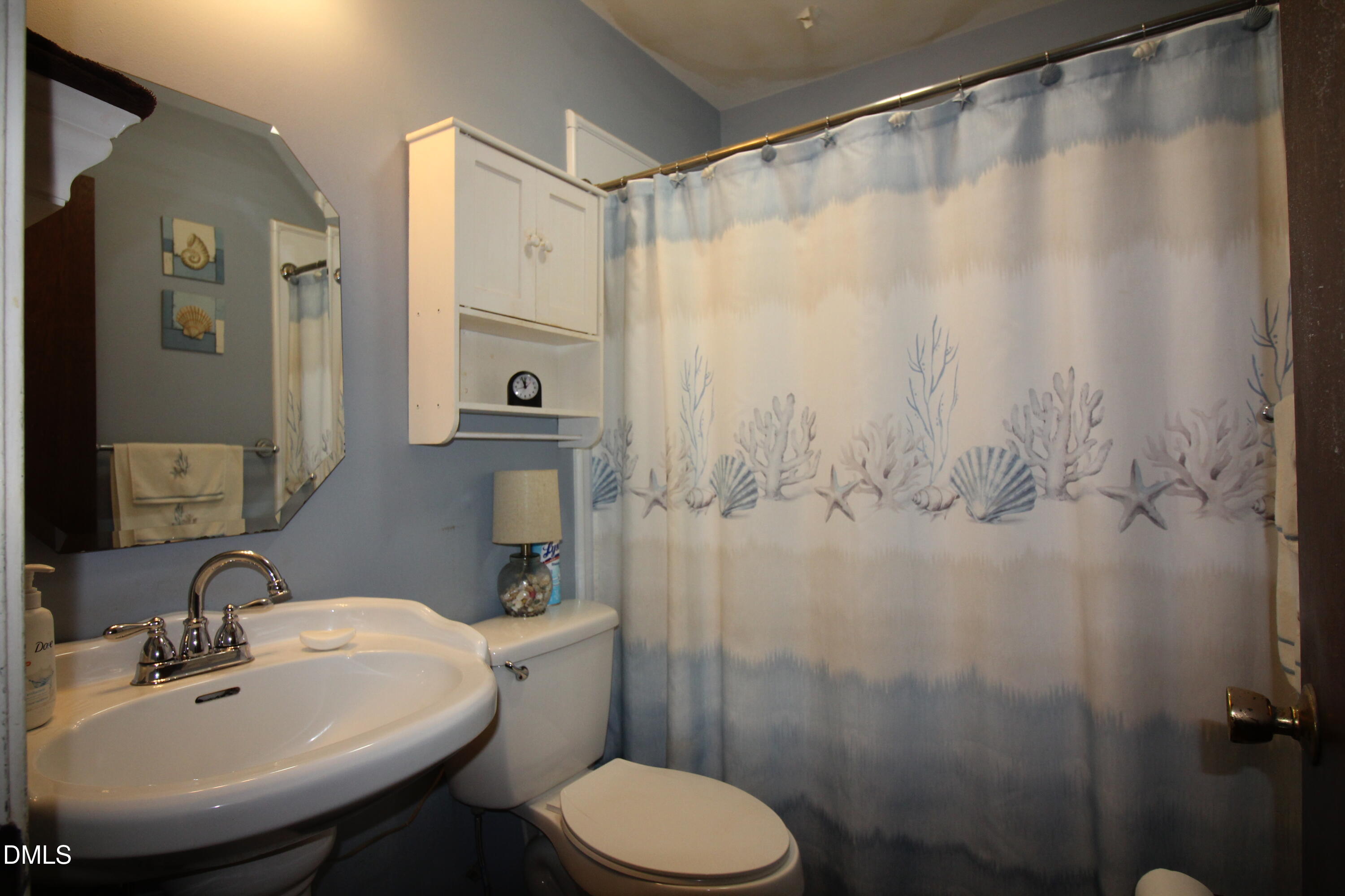 56 Ash Street Coats, NC 27521 - Photo 22 of 28 a bathroom with a sink toilet and shower
