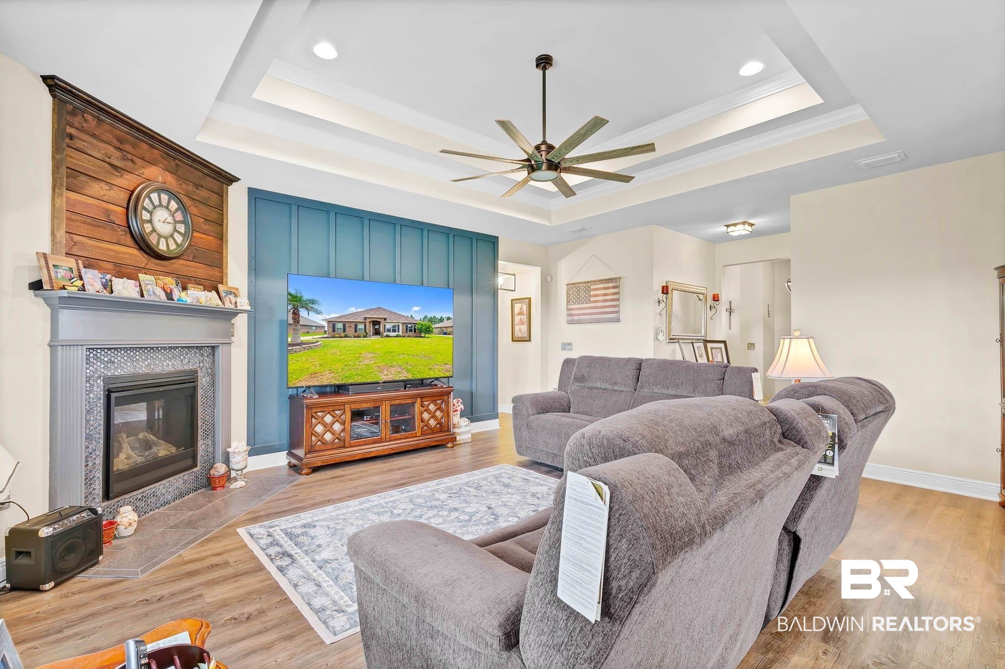 2049 Bourbon Street Foley, AL 36535 - Photo 11 of 56 Living room with a raised ceiling, ceiling fan, wood finished floors, a tiled fireplace, and recessed lighting