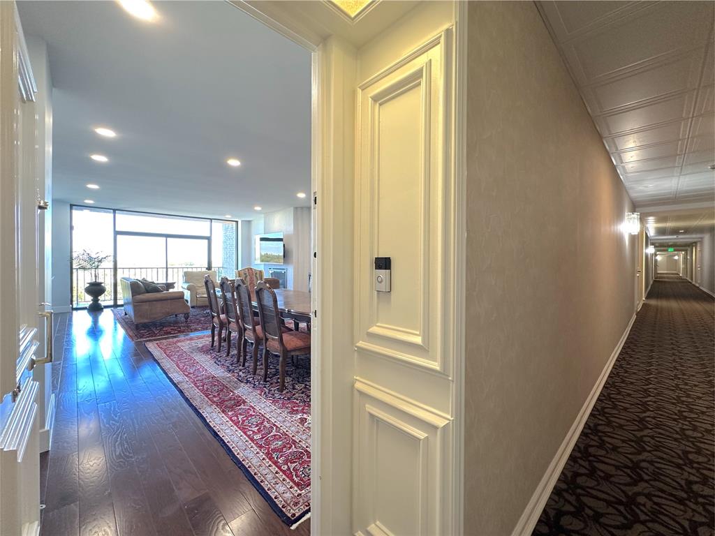 a view of a hallway with dining area and chandelier