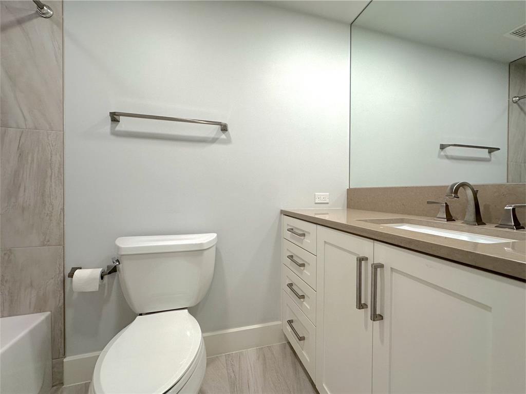 5200 Keller Springs Road, Unit 637 Dallas, TX 75248 - Photo 14 of 37 a white toilet sitting next to a bathroom sink