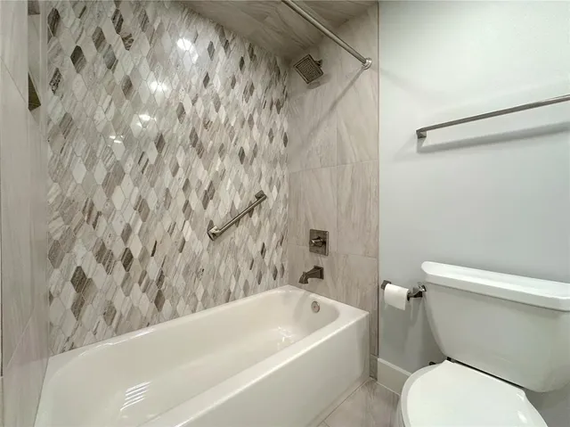 a bathroom with a toilet and a bathtub