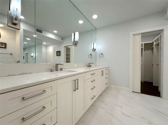 a bathroom with double sink and a mirror