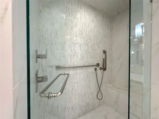 a bathroom with a glass shower door
