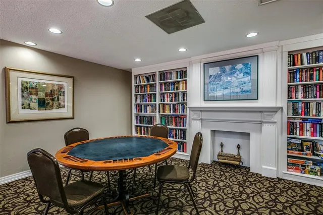 a dining room with furniture and a book shelf