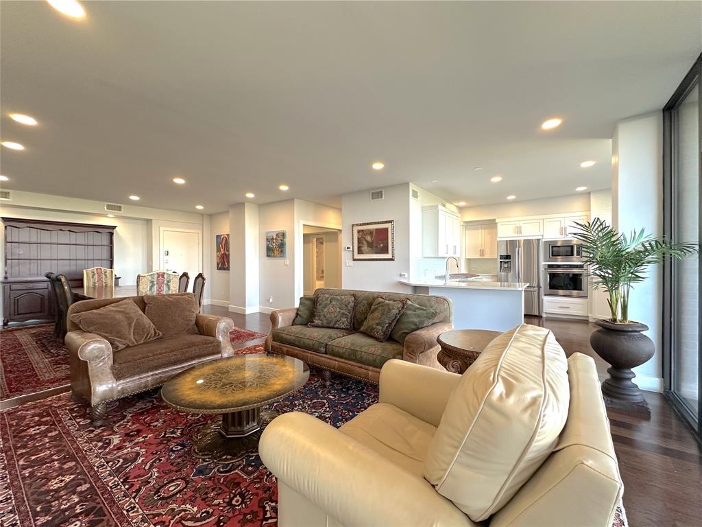 5200 Keller Springs Road, Unit 637 Dallas, TX 75248 - Photo 5 of 37 a living room with furniture and a view of kitchen