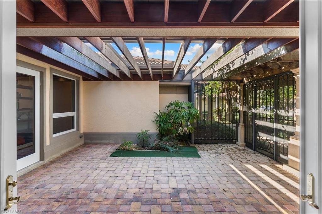 8840 Mariposa Court Naples, FL 34113 - Photo 12 of 50 a view of entrance with wooden floor and a window