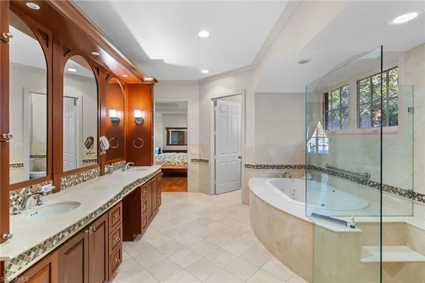 a large bathroom with a tub sink shower and mirror