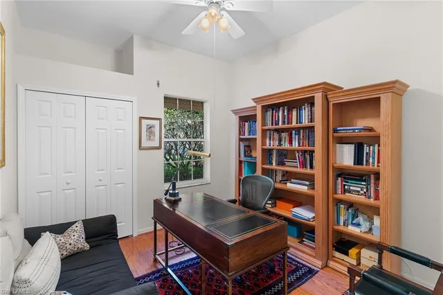 a living room with furniture and a book shelf